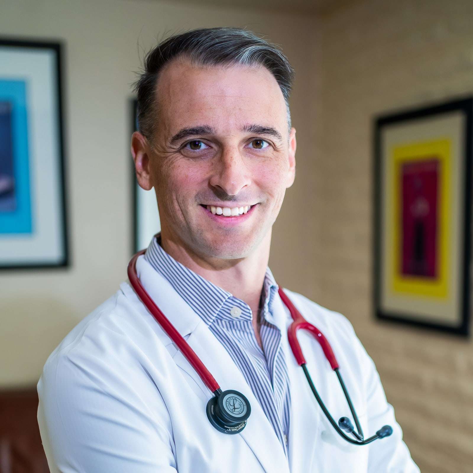 Portrait of Kyle Witt, MD, in a white coat with a stethoscope.